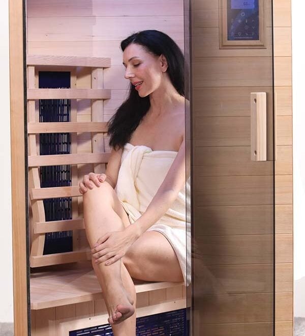 Woman inside the Transcend TR-1 Low EMF Infrared Sauna with the door open